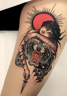 a woman holding a tiger on her arm with the sun in the sky behind it