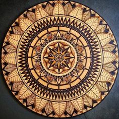 a wooden plate with an intricate design on it