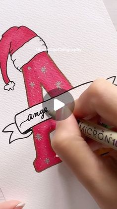 someone is drawing the letter a with colored pencils