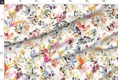 a white fabric with colorful flowers and leaves on the front, as well as a ruler