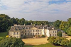 an aerial view of a large house surrounded by trees