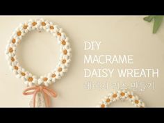 two bracelets made out of white and orange beads, with the words diy macrame daisy wreath