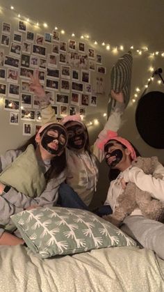 three people with masks on laying in bed