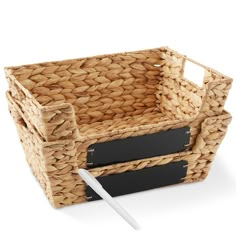 a wicker basket with two compartments and a chalkboard attached to the bottom, on a white background