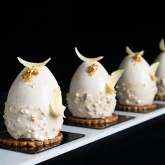 four desserts are arranged on small trays in order to look like they're ready for serving