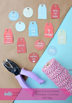 a pair of scissors and some tags on top of a piece of paper with the words free printable christmas gift tags