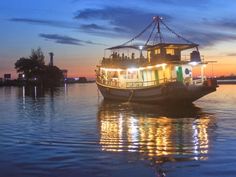 a boat is floating on the water at night