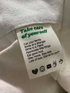 a label on a white shirt that says take care of yourself