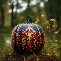 a painted pumpkin sitting in the grass