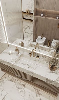 a bathroom with marble counter tops and gold faucets