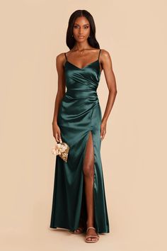 a woman in a long green dress with a slit down the side and one leg