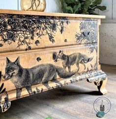 an image of a fox painted on the side of a wooden dresser with drawers and knobs