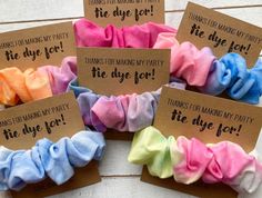 five different colored scrunffles with some saying on the tags in front of them