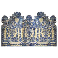 an ornately decorated blue and white headboard with intricate carvings on the back side