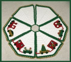 a crocheted christmas tree skirt with cars and trees on it