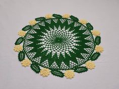 a green doily with yellow flowers on it