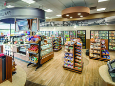 the inside of a grocery store filled with lots of food and drink bottles on display