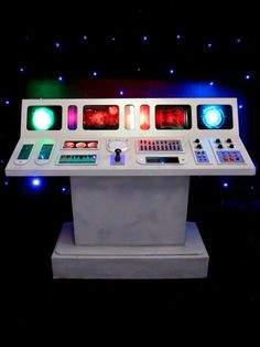 an electronic control panel in the dark with blue and red lights on it's sides