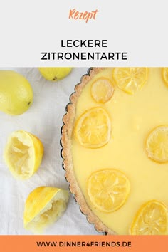 a lemon tart on a white table with some lemons around it and the words leckere zirronentate