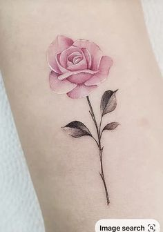 a pink rose tattoo on the left thigh