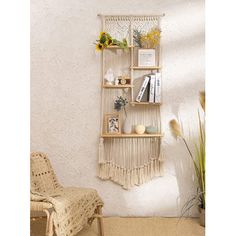 a room with a chair, book shelf and potted plant on the wall next to it