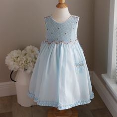 This Girl's Luli & Me Smocked Dress Is Adorable! Done In A Soft, Pale Blue And Beautiful Shades Of Spring Floral Embroidery.The Sleeveless Dress Has A Smocked Bodice Done With Two Sizes Of Lattice Design Smocking. Starts Larger At The Top Of The Dress And Finishes Off With A Smaller Design. The Top Of The Shoulders Have A Row Of Embroidered Flowers Done In A Tangerine, Coral And Pink With Green Leaves. Where The Skirt Gathers At The Waist Is A Scalloped Garland Of A Matching Floral Vine, Done In Light Blue Sleeveless Dress For Baptism, Summer Baptism Smocked Dress, Girls Smock, Lattice Design, White Slip, Matching Headband, Smocked Dress, Floral Vine, Size 4t