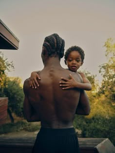 a man holding a child in his arms