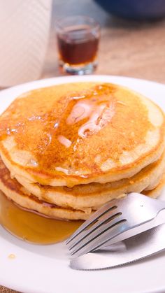 pancakes on a plate with syrup and a fork