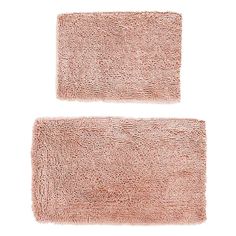 two pink bath mats sitting next to each other