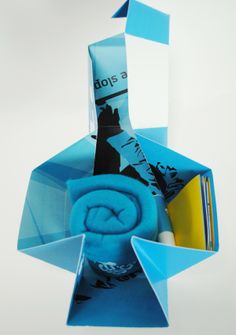 an origami sculpture made out of blue folded paper and various other things in it