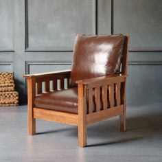 a brown leather chair sitting on top of a hard wood floor