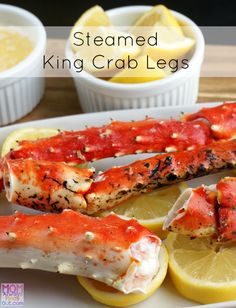 steamed king crab legs on a plate with lemons