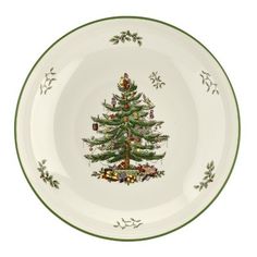 a white plate with a green christmas tree on the front and gold trimmings