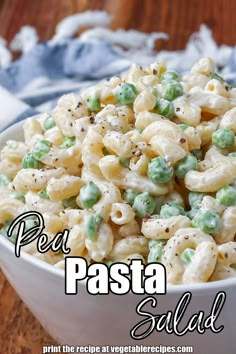 pasta salad in a white bowl on a wooden table with the words per pasta salad