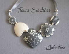 the necklace is decorated with flowers and hearts