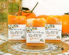 three soap bars with oranges in the background