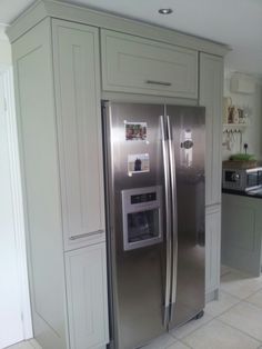 two pictures of refrigerators in the same kitchen, one is stainless steel and the other has white cabinets