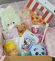 a box filled with lots of toys and other items sitting on top of a table