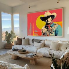 a living room filled with furniture and a large painting on the wall above it's windows