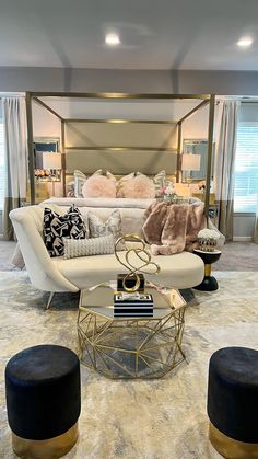 a living room filled with lots of furniture and pillows on top of a carpeted floor