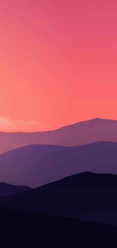 the sky is pink and purple as the sun goes down in the distance over mountains