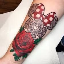 a red rose on the left arm with black and white designs