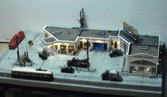 a model train station with cars and trucks