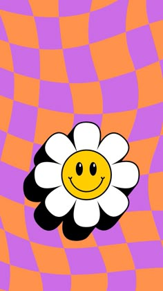 a flower with a smiley face on an orange and purple checkerboard pattern background