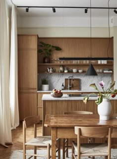 a wooden table and chairs in a room