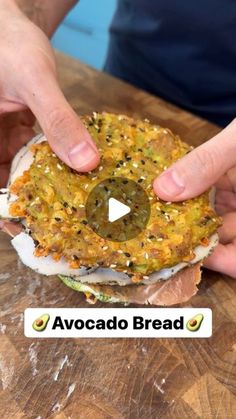 two hands grabbing an avocado bread sandwich