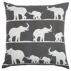 an elephant print pillow is shown on a gray background with white elephants in the same pattern