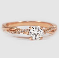 a rose gold engagement ring with a round diamond in the center