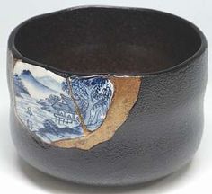 a black bowl with blue and white designs on it