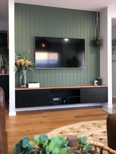 a large flat screen tv mounted to the side of a wall in a living room